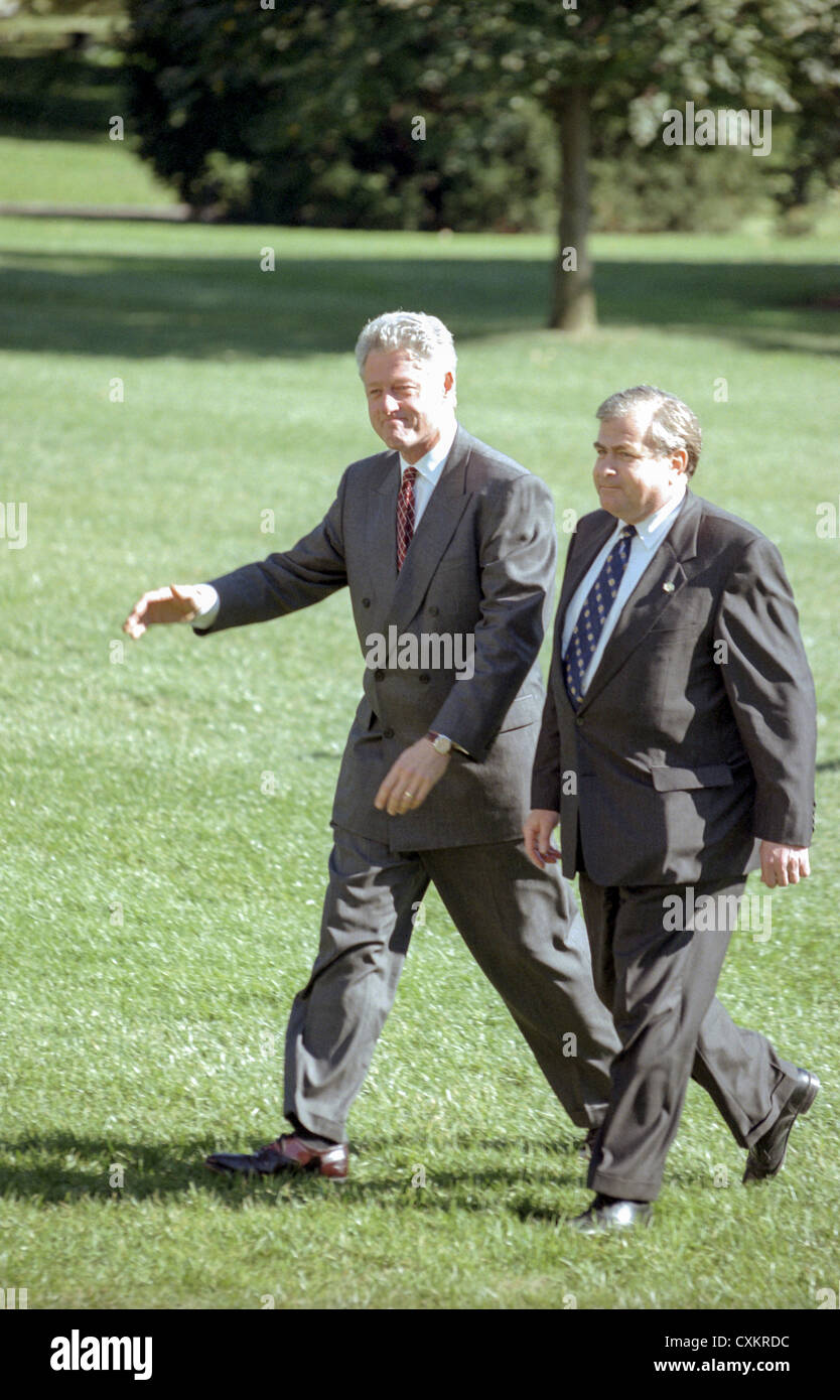 US President Bill Clinton waves as he walks with National Security