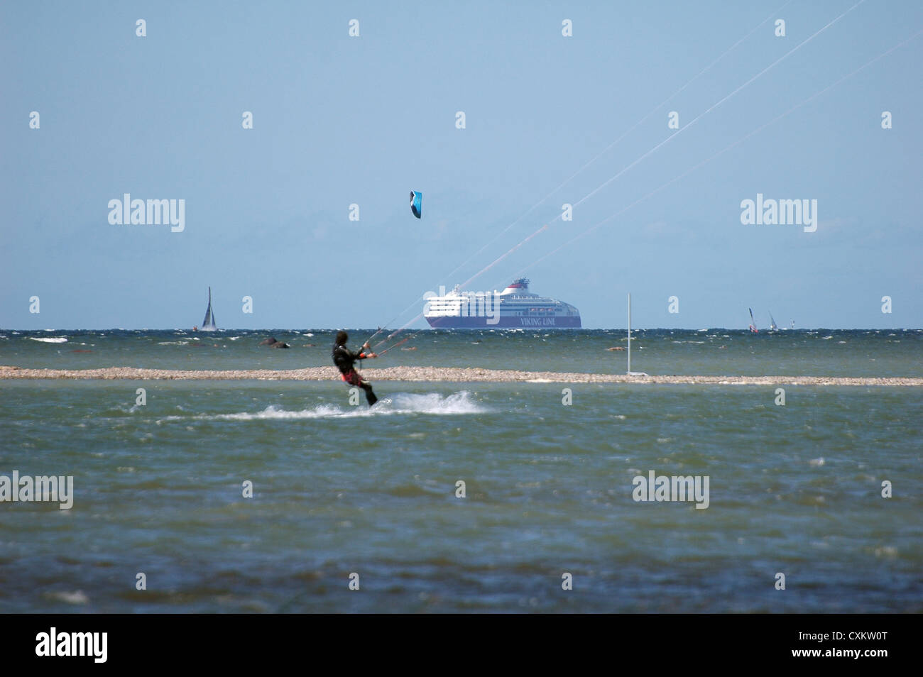 Kite-surfer in ocean with cruise ship on background Stock Photo