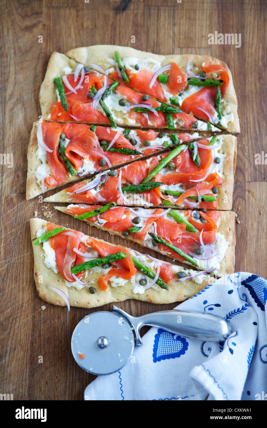 Thin Crust Salmon Pizza with Onions, Capers and Asparagus Stock Photo