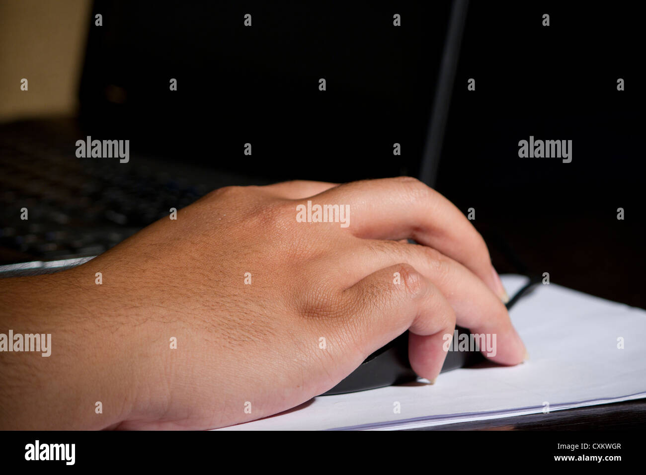 hand clicking mouse laptop lighting Stock Photo