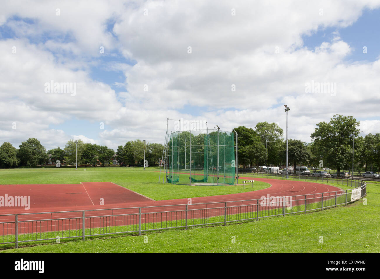 Field throwing event nets and running track at Bury Athletics Club, Lancashire. Stock Photo