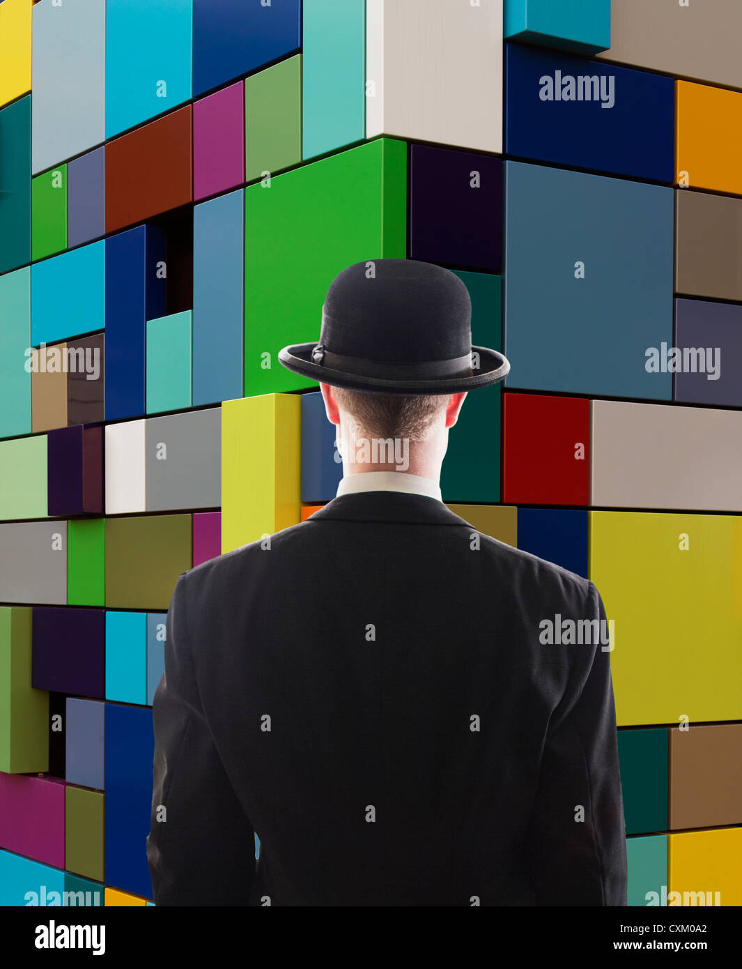 man facing multi-colored wall Stock Photo