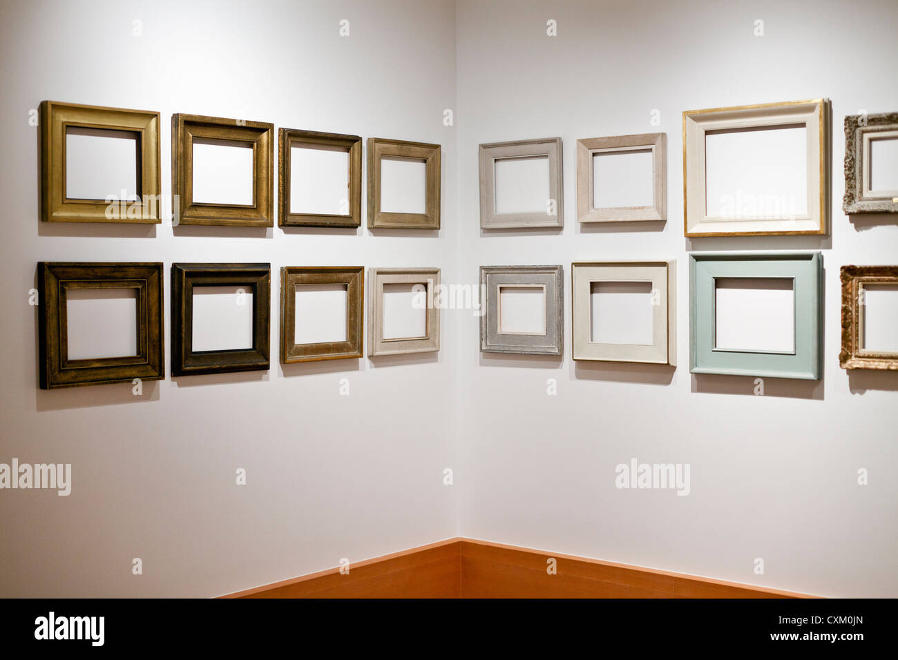 empty picture frames arranged on a white wall Stock Photo