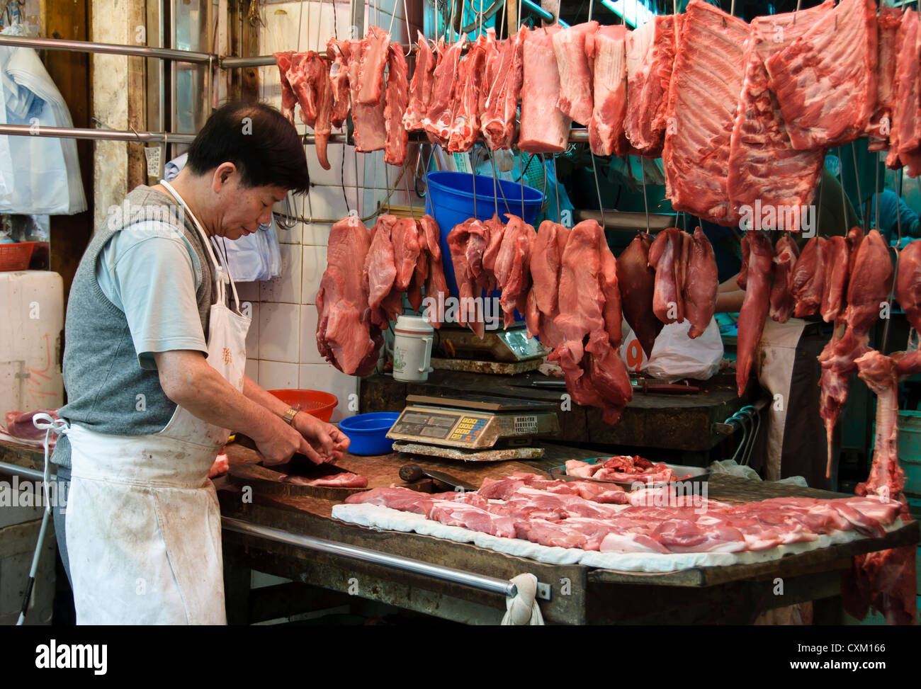 Butcher at Bowrington Road wet market, Hong Kong Stock Photo