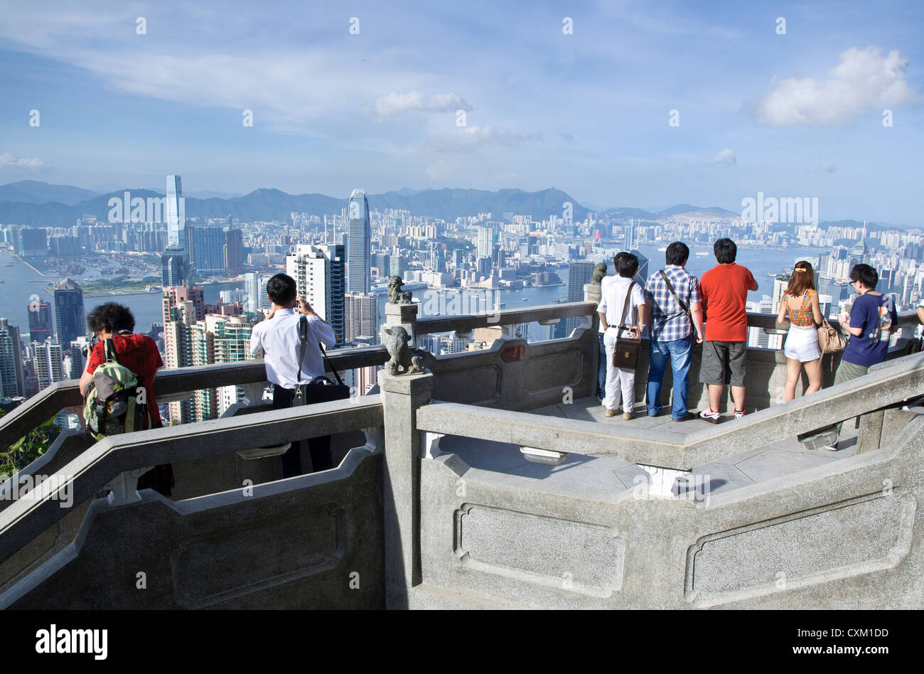 Tourists overlooking the Hong Kong skyline from The Peak Stock Photo