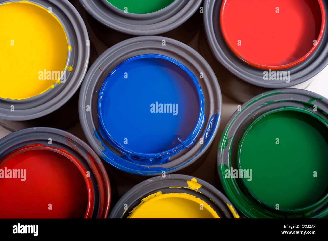 Colorful cans of paint on a white background forming a colorful