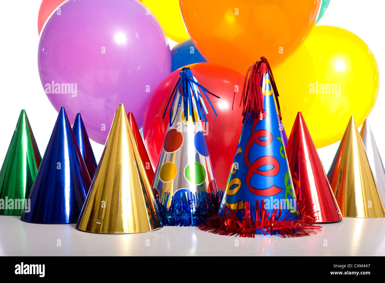 Birthday party background with party hats, floating balloons and streamers Stock Photo