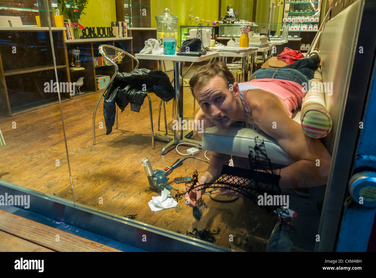 New York City, NY, USA, Man Removing Window Decals on Glass from inside