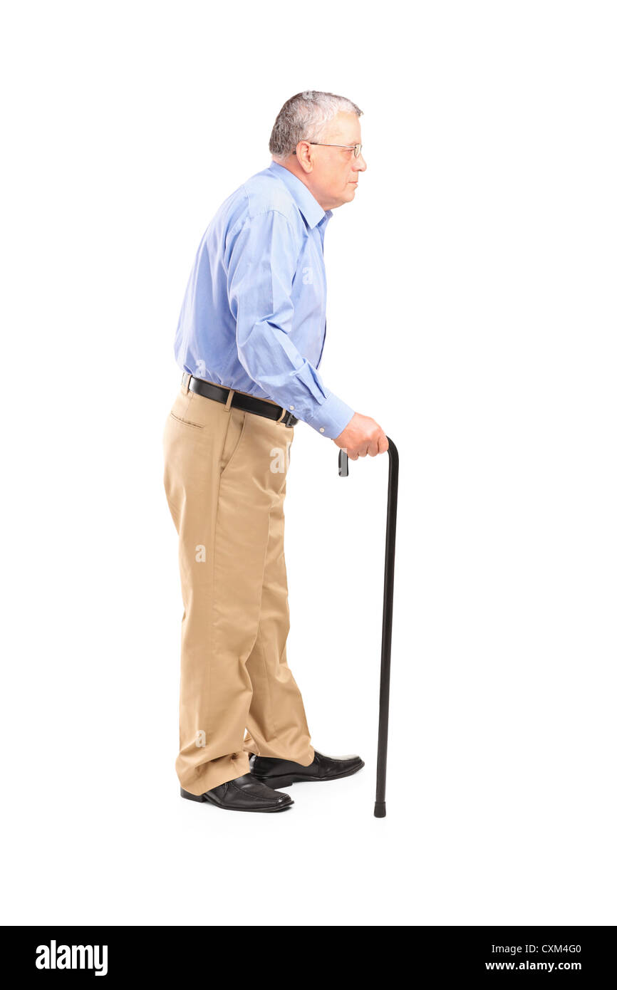 Full length portrait of a senior man walking with a cane isolated on