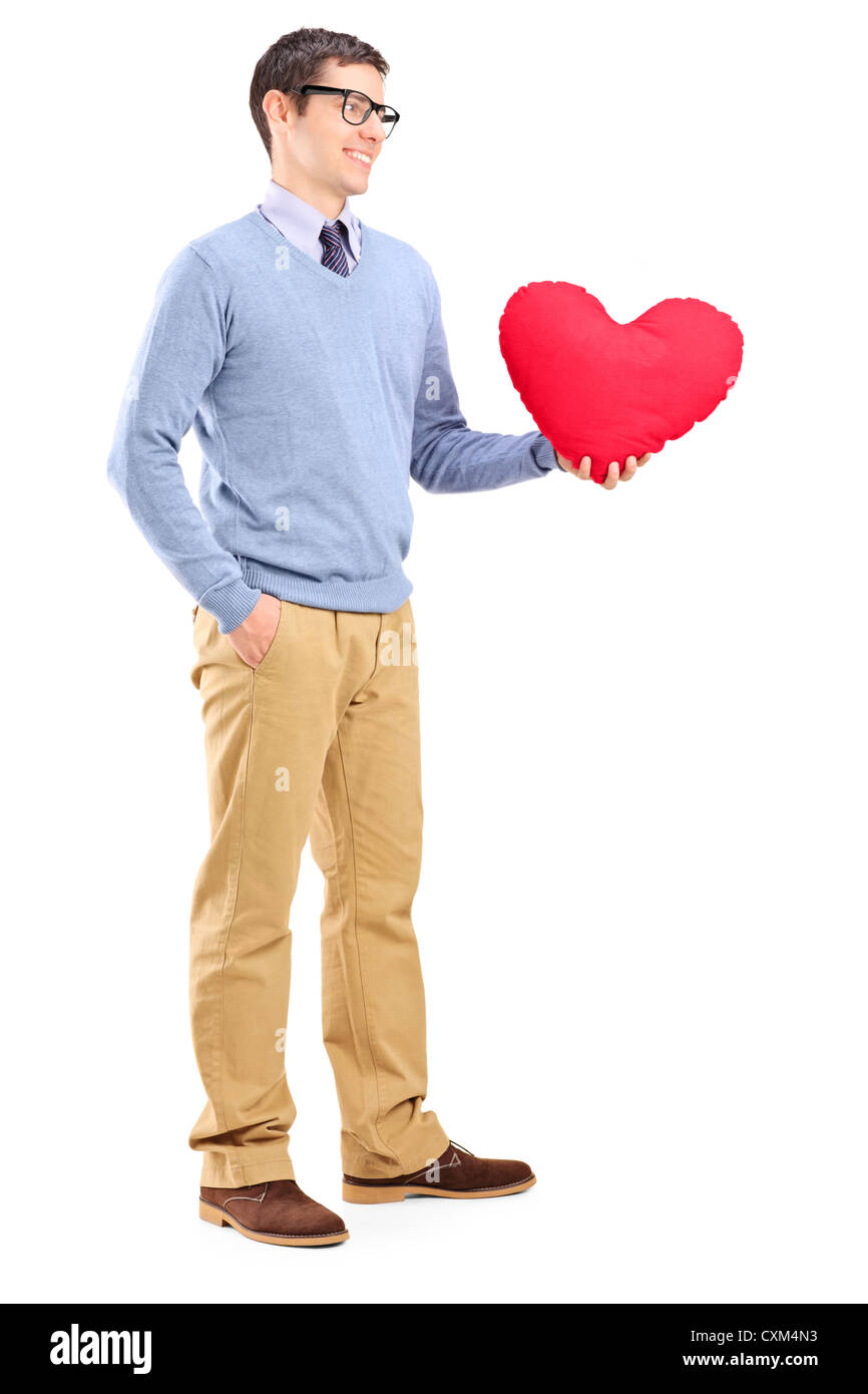 Full length portrait of a young man holding a red heart isolated on ...