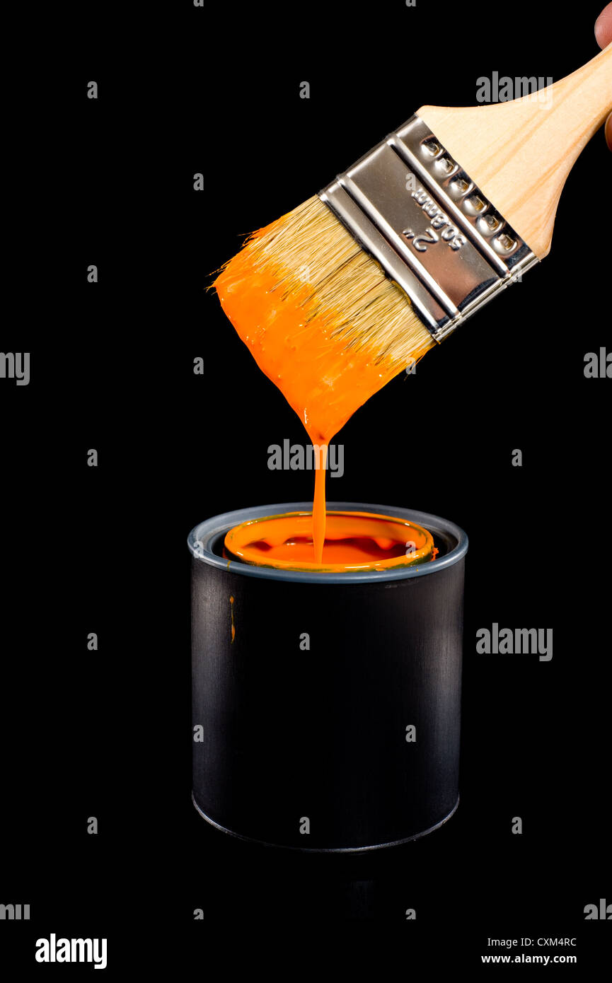 Colorful can of orange paint with a paint brush with dripping paint