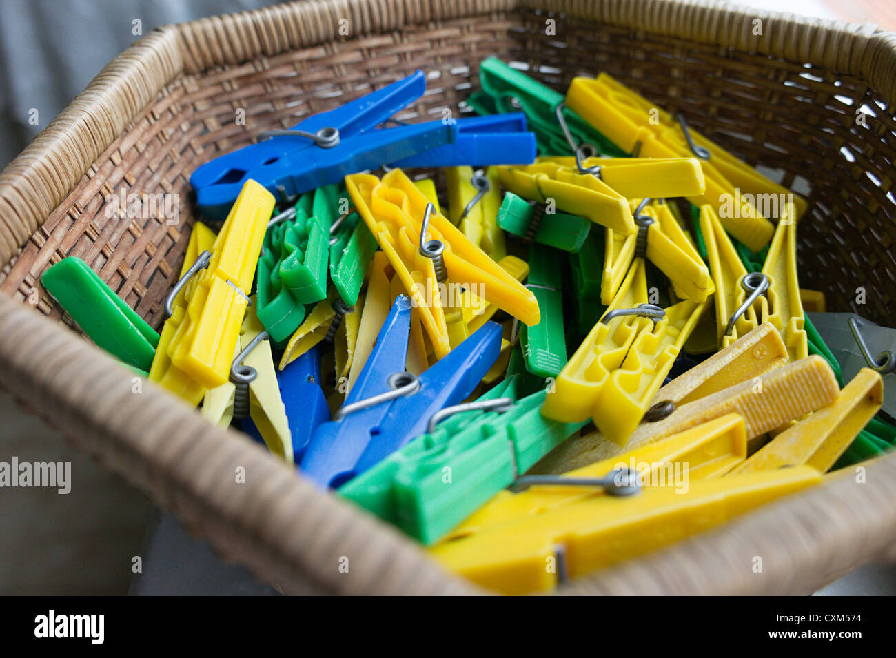 Pile of yellow, blue and green plastic clothes pegs Stock Photo Alamy