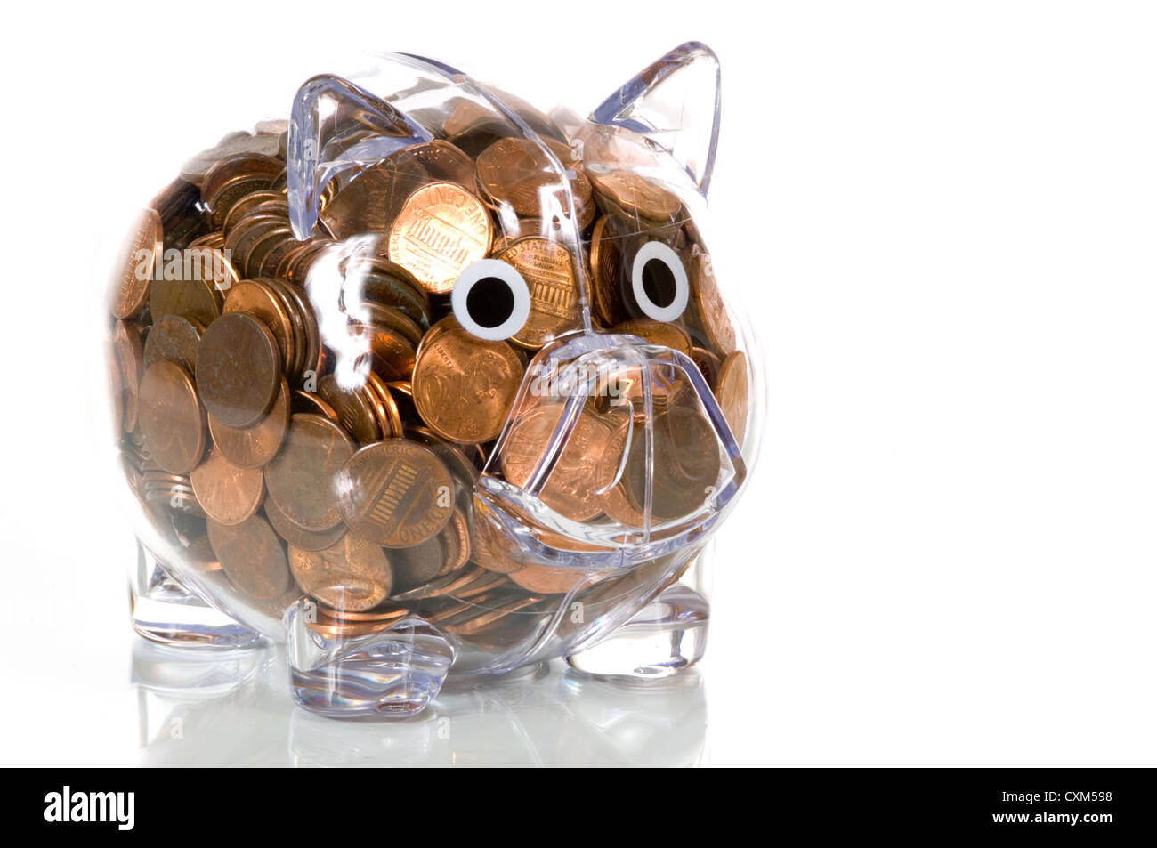 Clear plastic piggy bank stuffed full of pennies Stock Photo Alamy