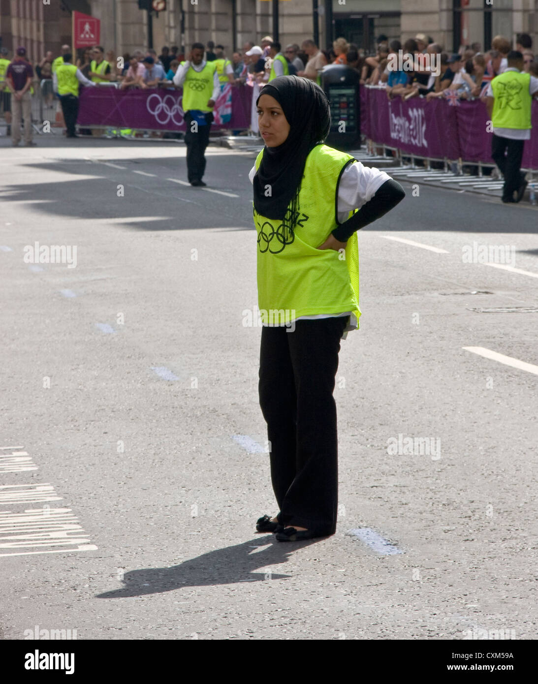 A young Muslim woman marshal at the London 2012 Olympic marathon England Europe Stock Photo