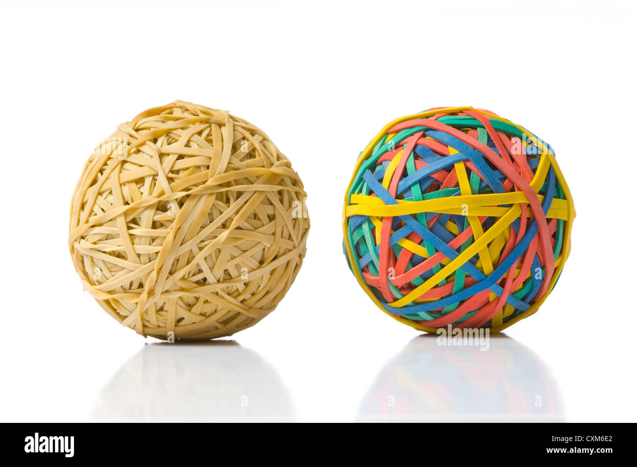 Two rubberband balls, illustration of opposites, or being different and refusing to be ordinary or boring Stock Photo