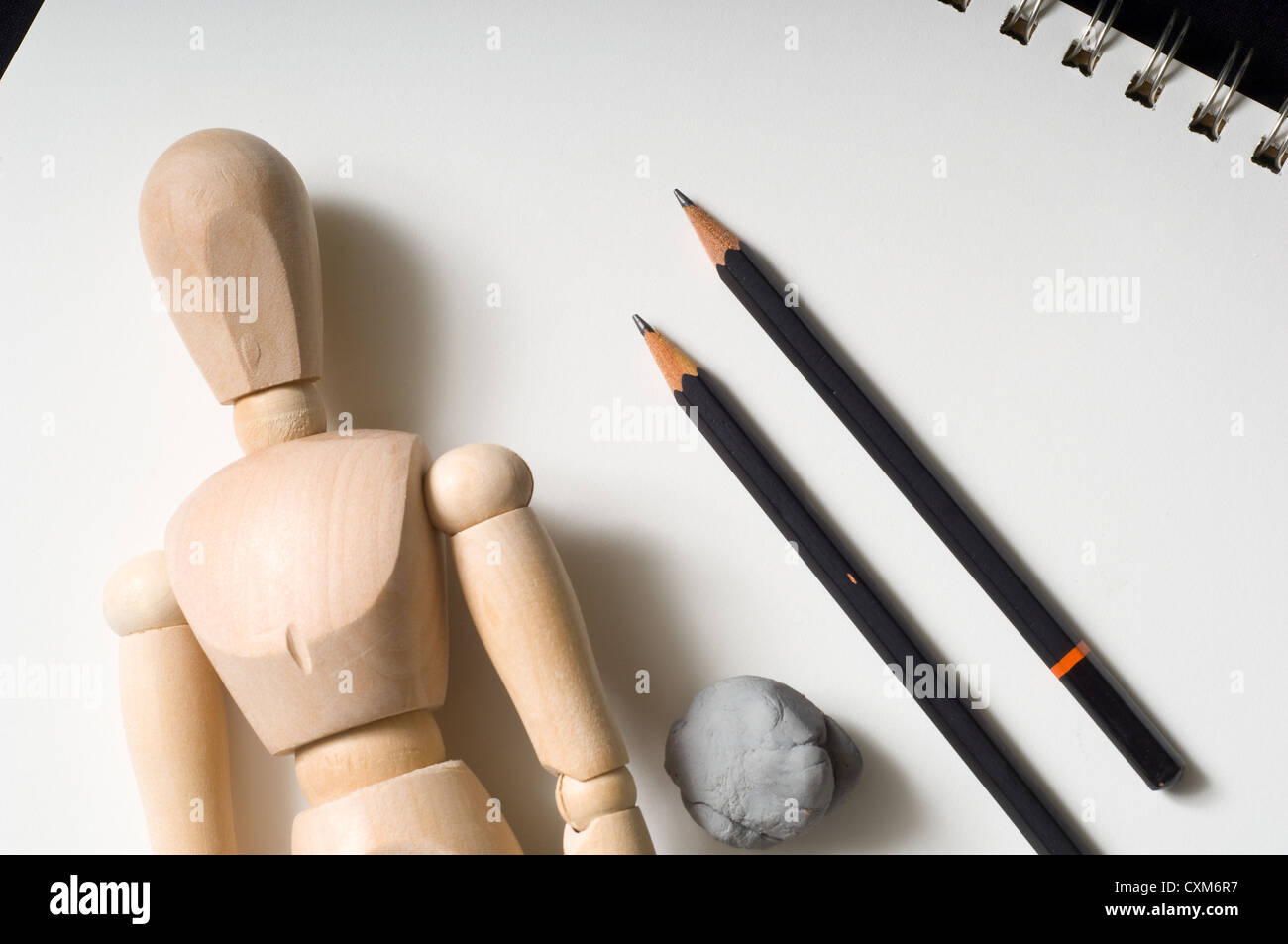 A drawers tools including a wooden people poser, pencils, eraser on a sketch tablet Stock Photo
