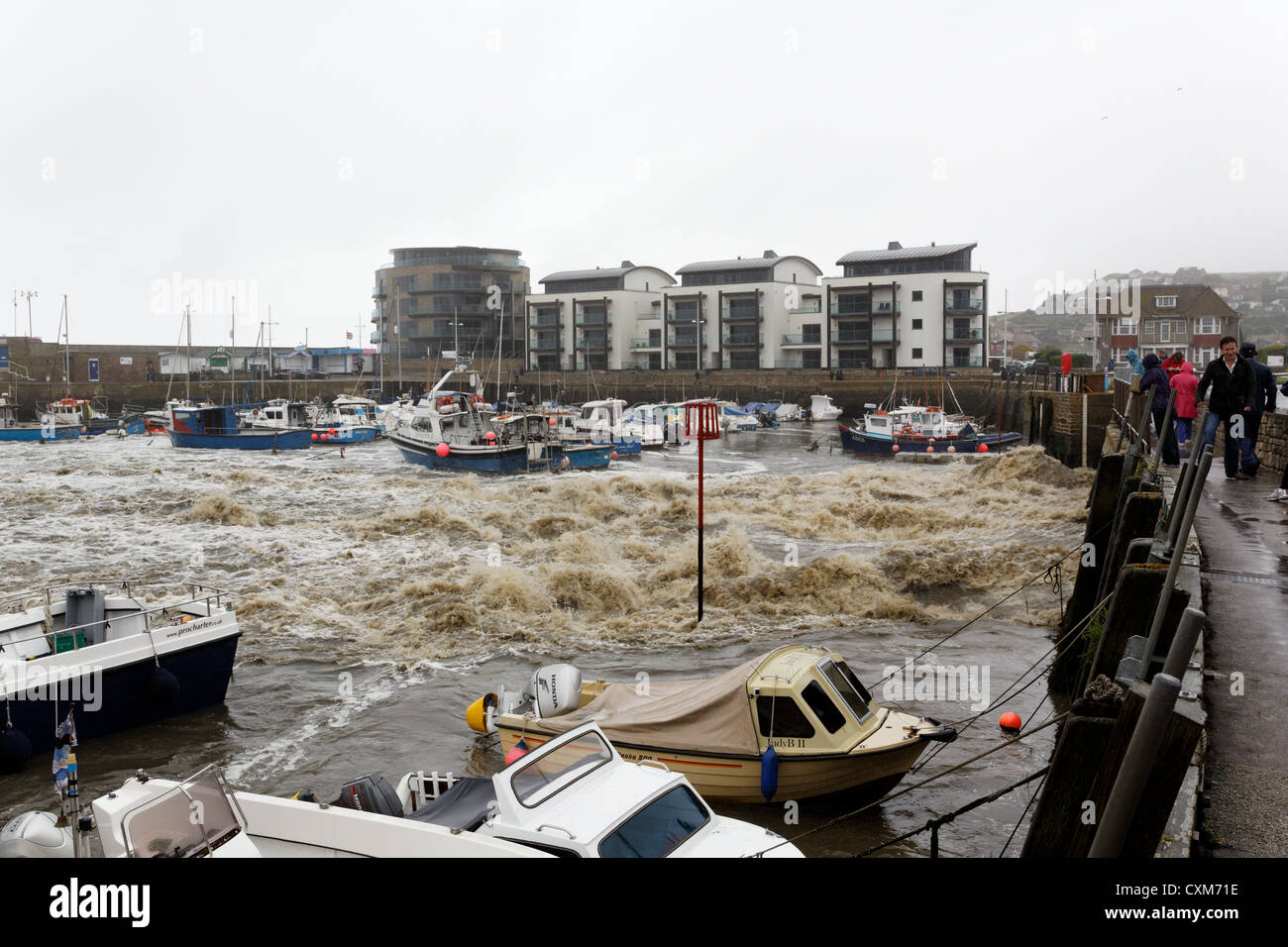 Run off from the heavy rain pours into West Bay Harbour near Bridport Dorset Stock Photo