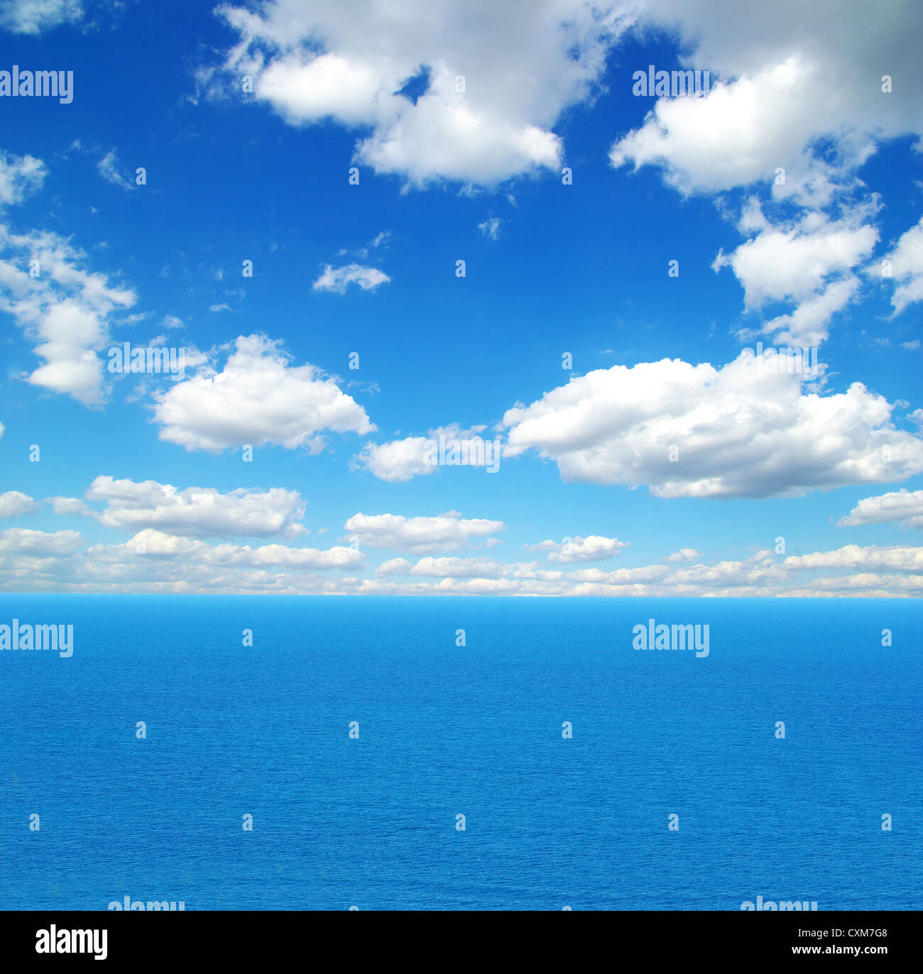 cloudy blue sky above a surface of the sea Stock Photo - Alamy