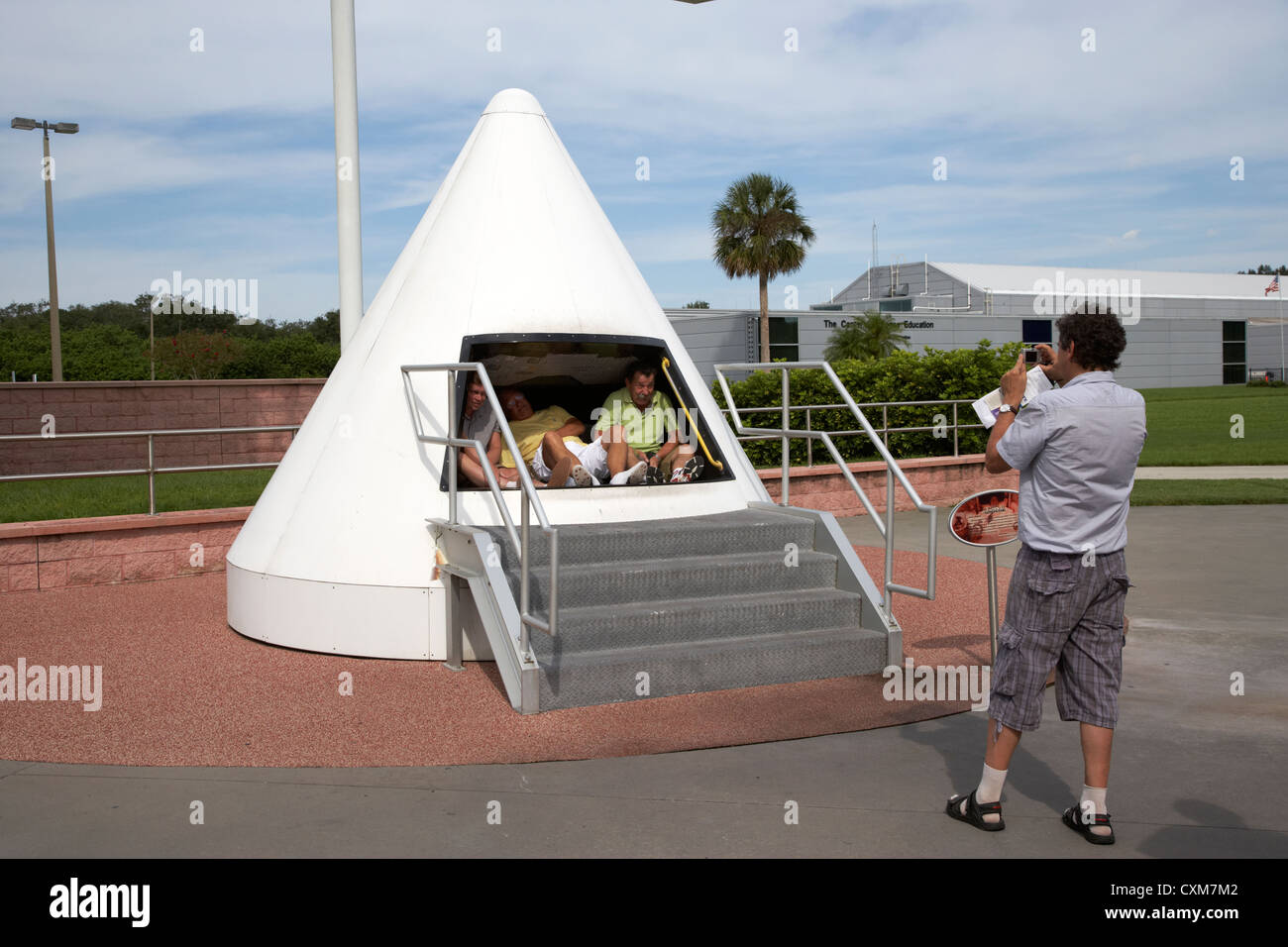 tourists taking photos in a mock space capsule at the Kennedy Space Center Florida USA Stock Photo