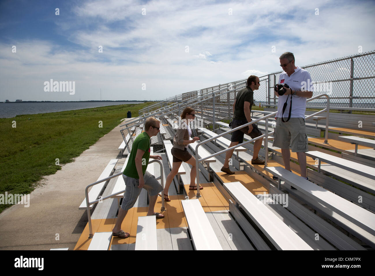 tourists on guided tour of Kennedy Space Center climb a launch viewing platform Florida USA Stock Photo