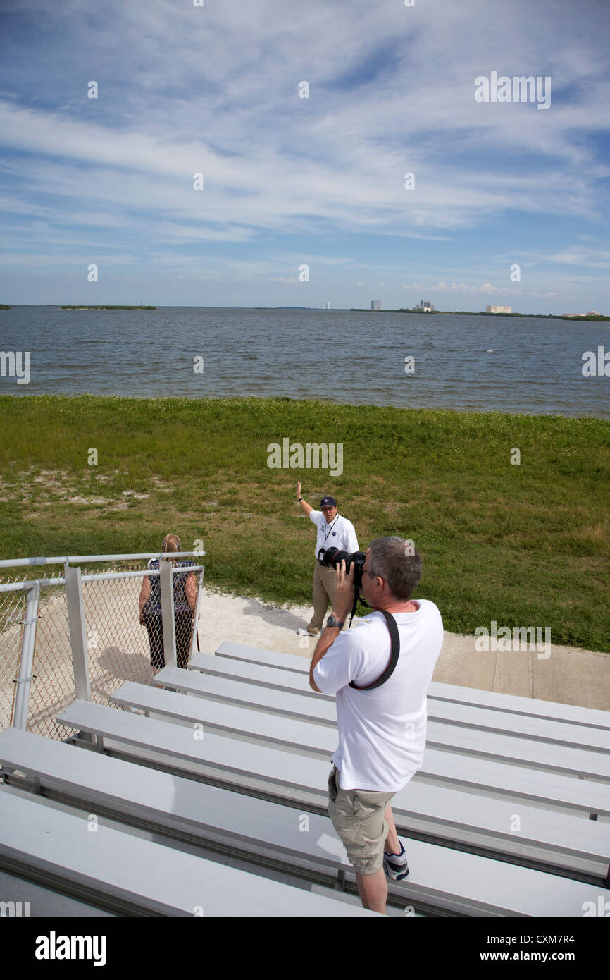 tourists on guided tour of Kennedy Space Center climb a launch viewing platform Florida USA Stock Photo