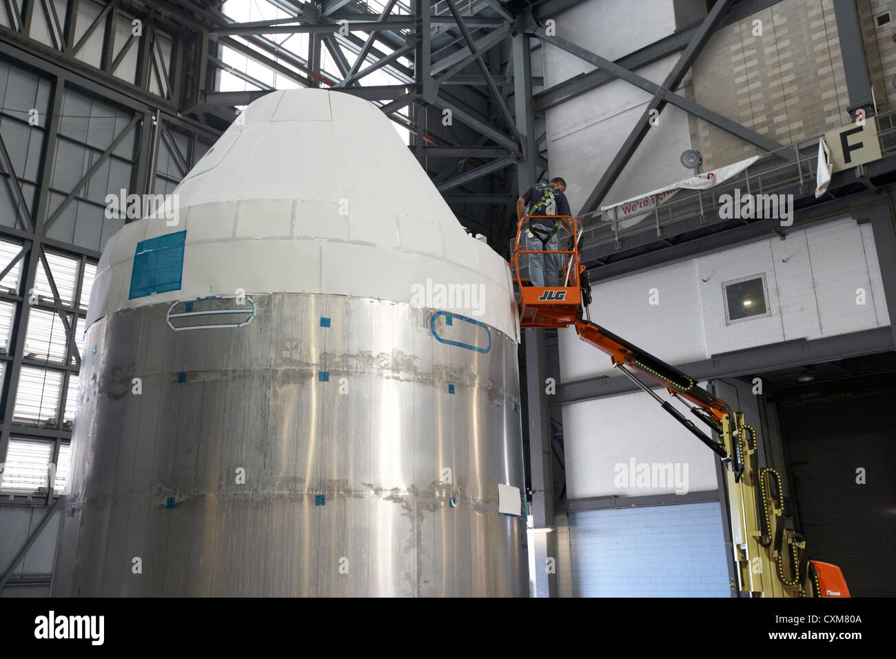 worker works on mockup of the nasa orion command and service modules Kennedy Space Center Florida USA Stock Photo