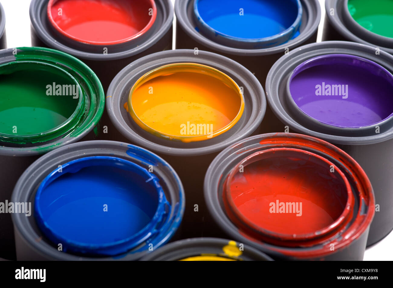 Colorful cans of paint on a white background forming a colorful