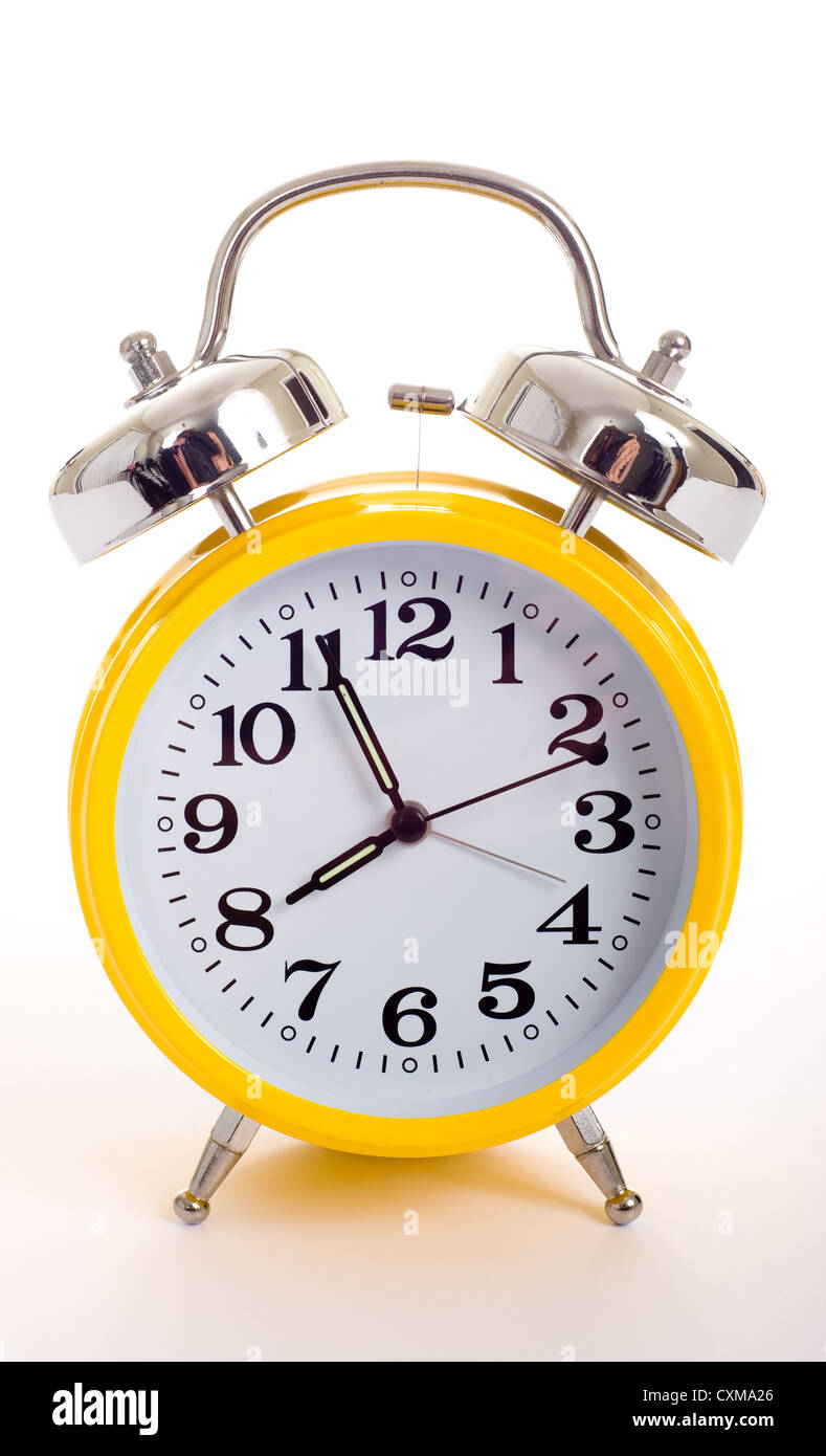 a vintage, antique yellow alarm clock on a white background Stock Photo ...
