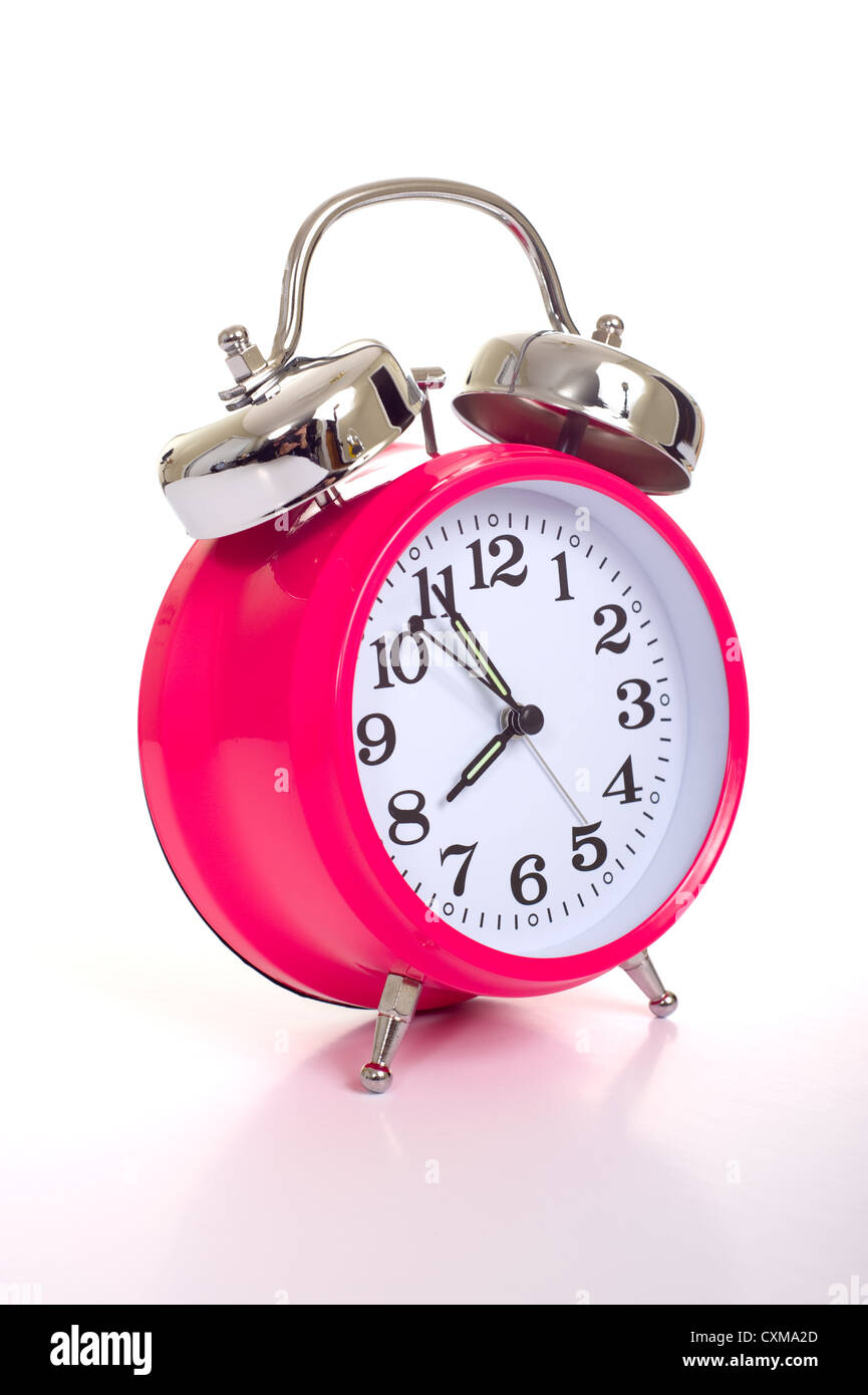 a bright pink vintage looking alarm clock on a white background Stock Photo Alamy