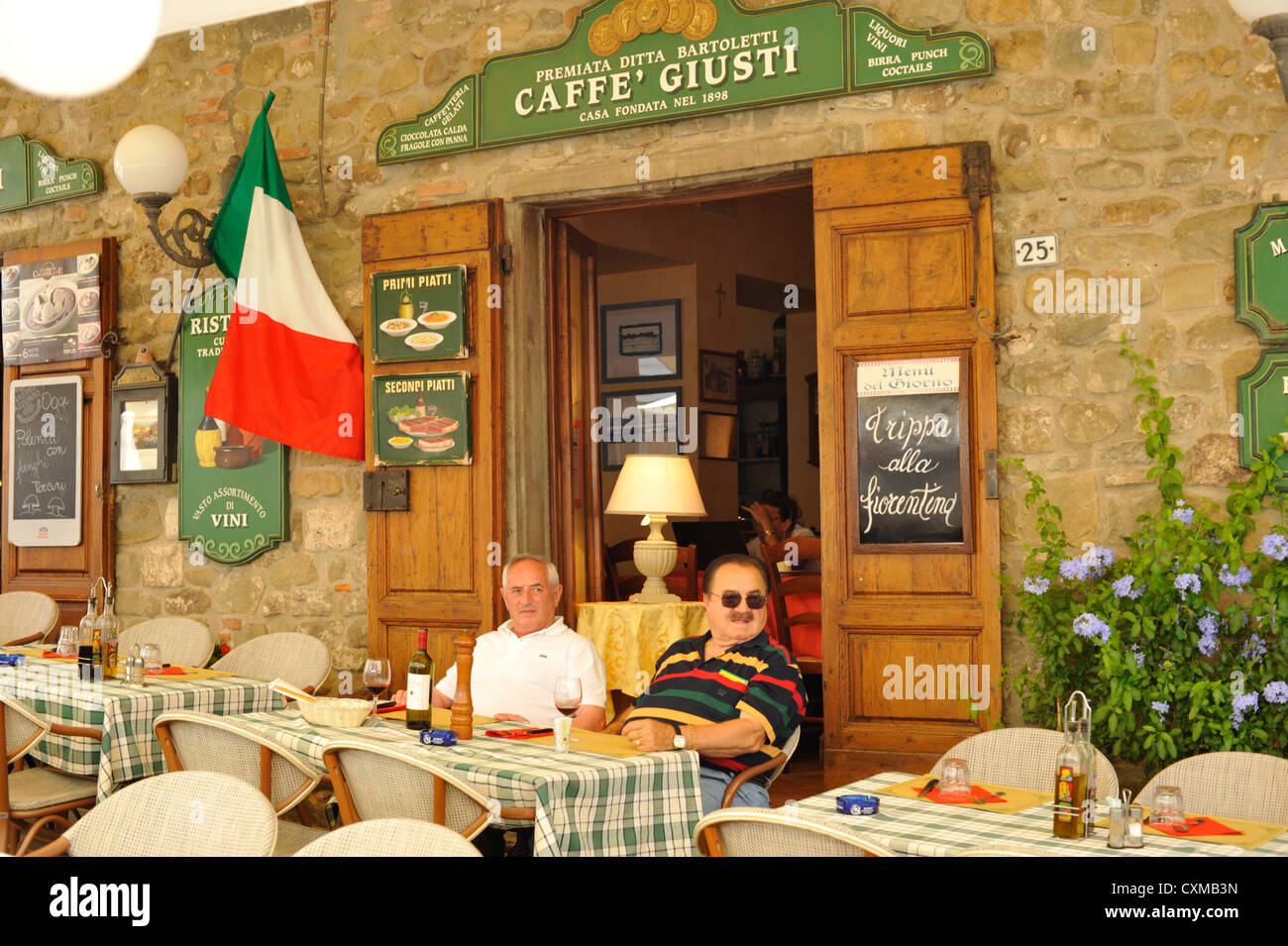2 Italians enjoying a bottle of wine outside Caffe Giusti, In Piazza Giusti Montecatini Alto Tuscany Italy Stock Photo