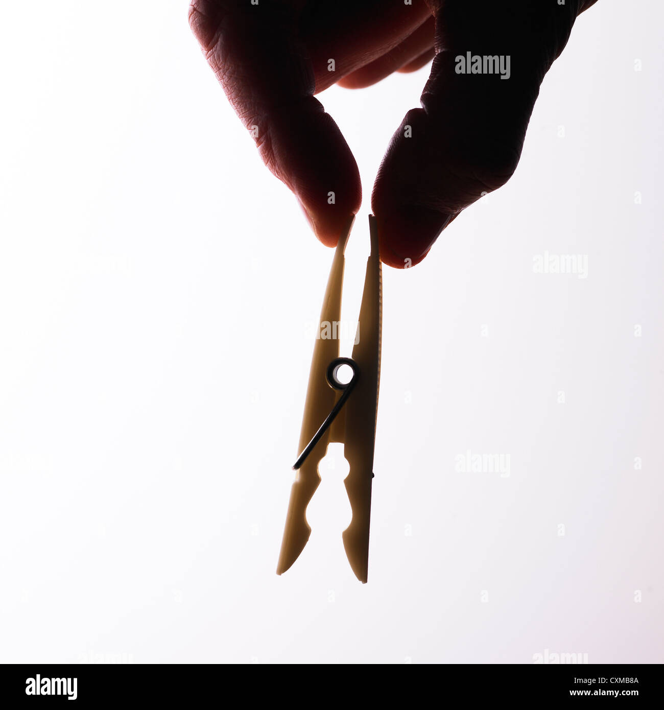 Fingers opening clothes peg on white background Stock Photo Alamy