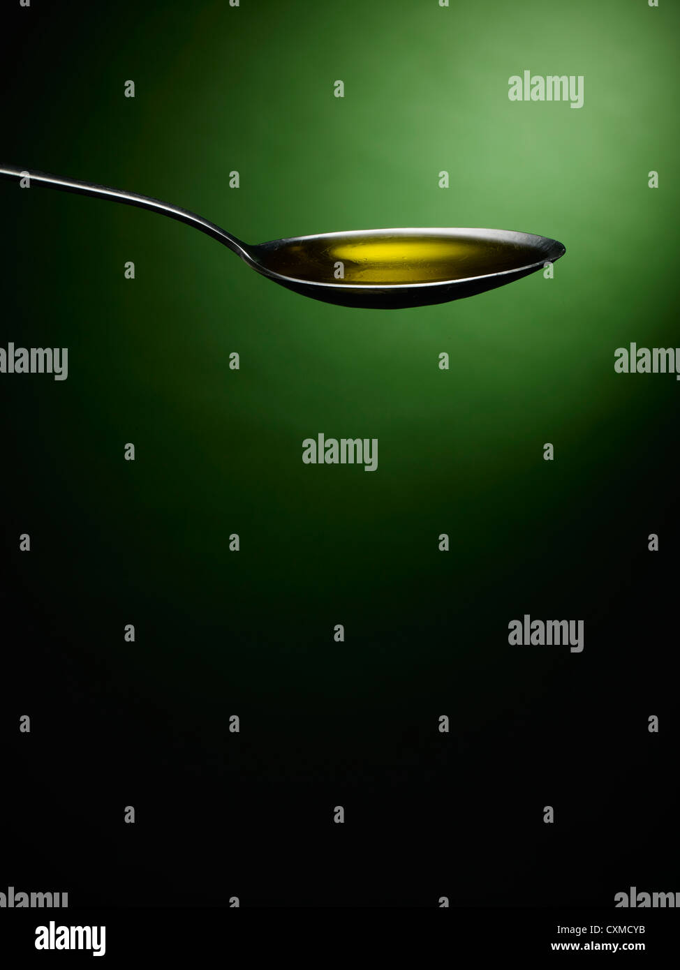Spoon with oil Stock Photo