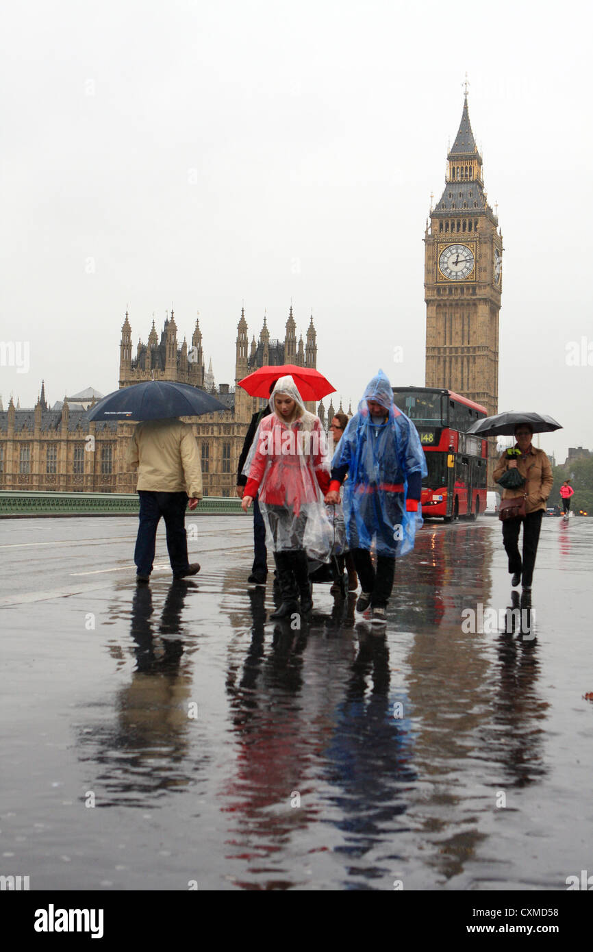 people walking over Westminster Bridge, in the rain, with Big Ben in