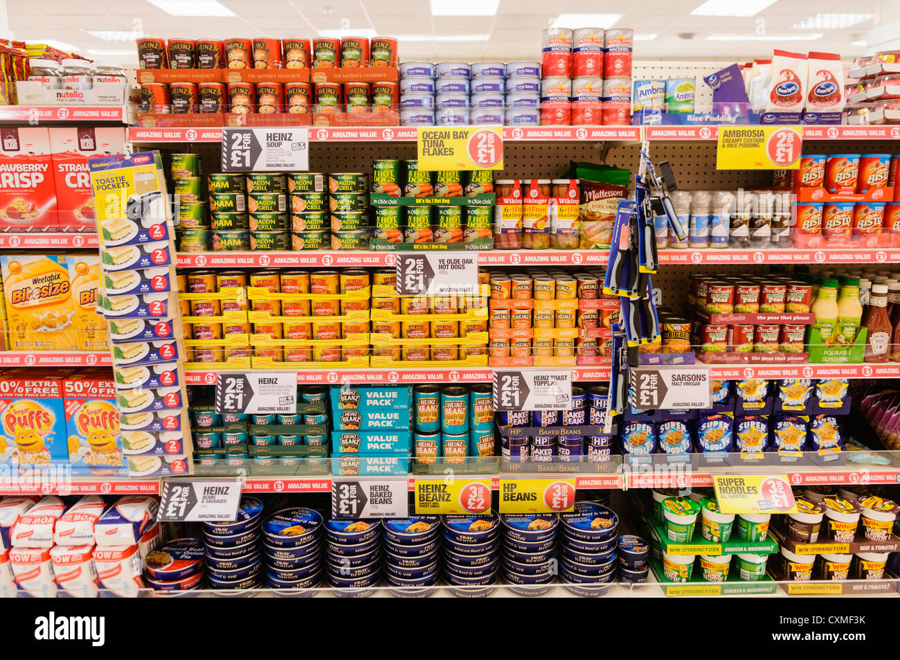 Food products on sale on the shelves in a Poundland shop store. Stock Photo