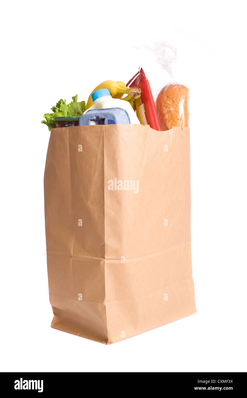 A brown paper bag full of groceries on a white background, with bread