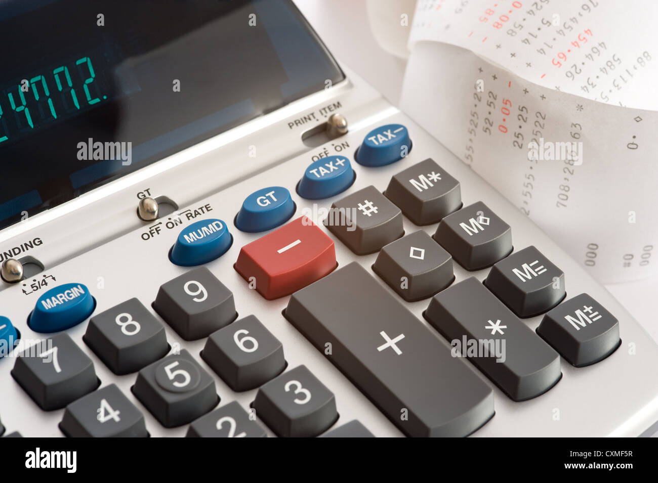 An adding machine or calculator with adding machine tape or paper Stock ...