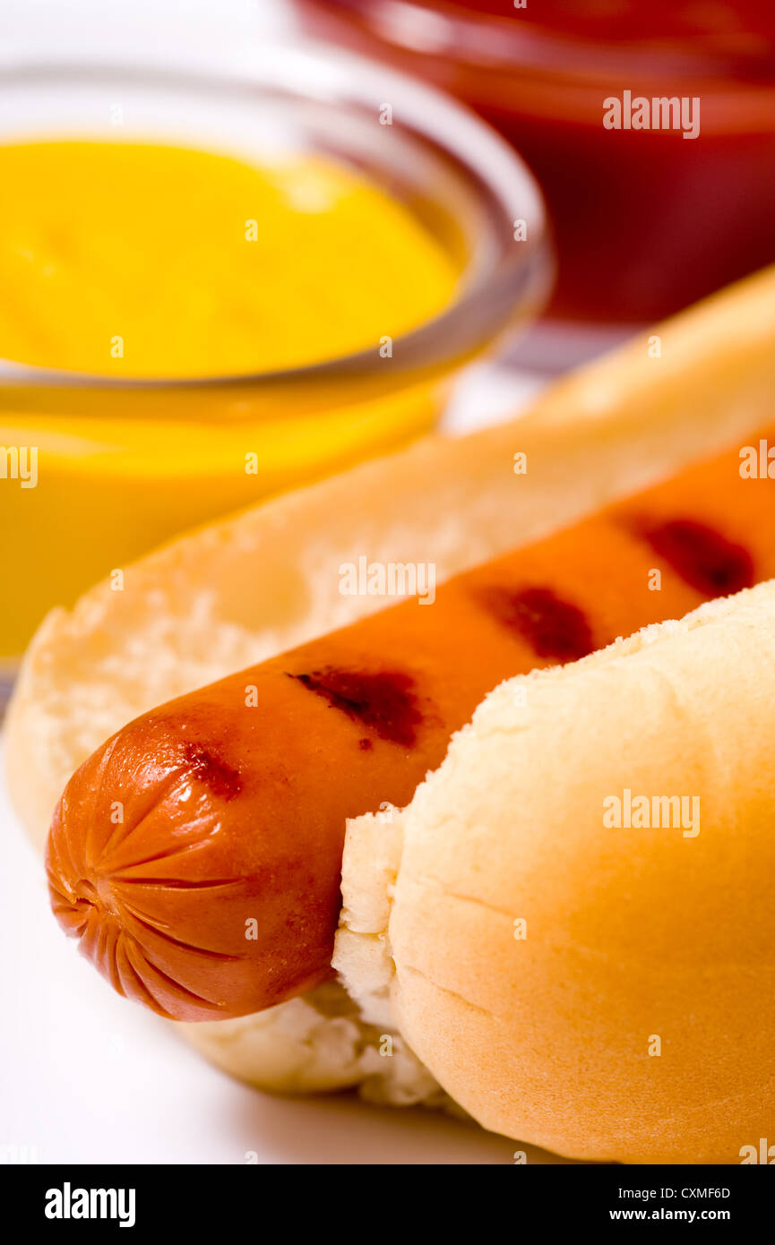 Freshed grilled hot dog with mustard and ketchup in the background, cook out or bar-b-q summertime. Stock Photo