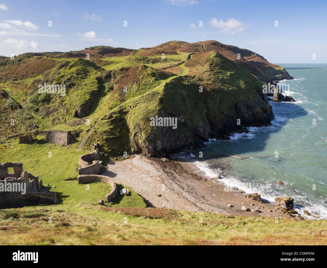 View of Isle of Anglesey Coastal Path Wales coast footpath and rugged coastline in AONB at Porth Llanlleiana Bay Cemaes Anglesey Wales UK Britain Stock Photo