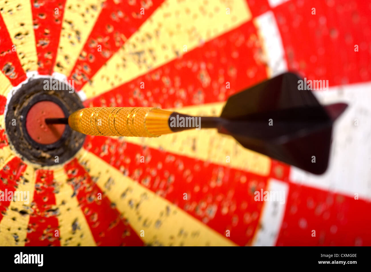 A game of darts with a dart in the bullseye of the dart board Stock