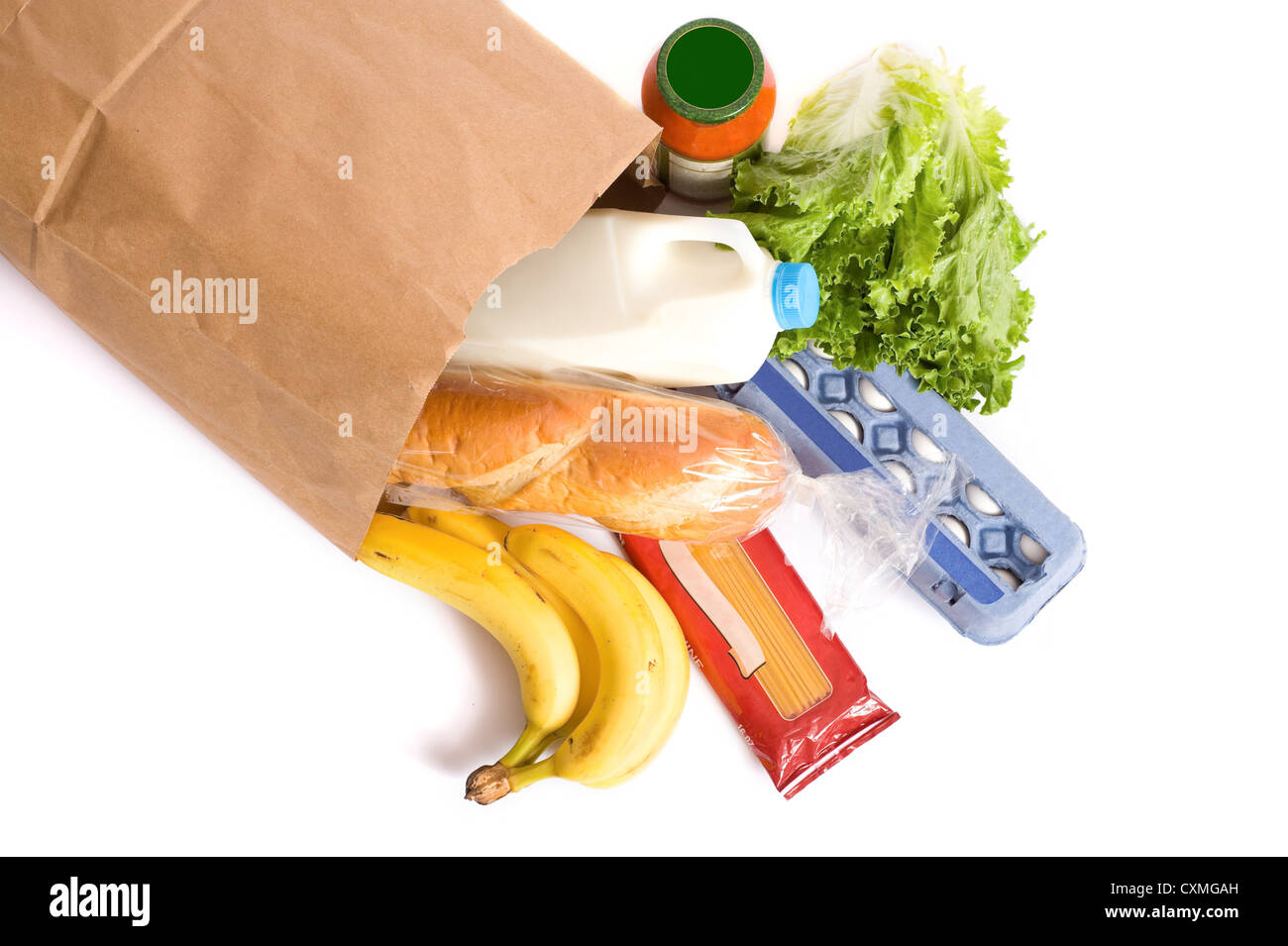 A brown paper bag full of groceries on a white background, with bread
