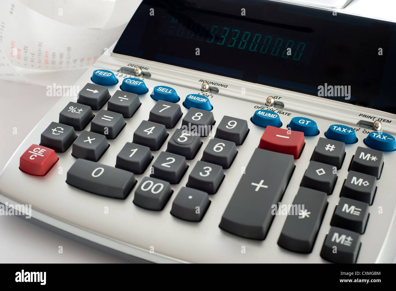 An adding machine or calculator with adding machine tape or paper Stock