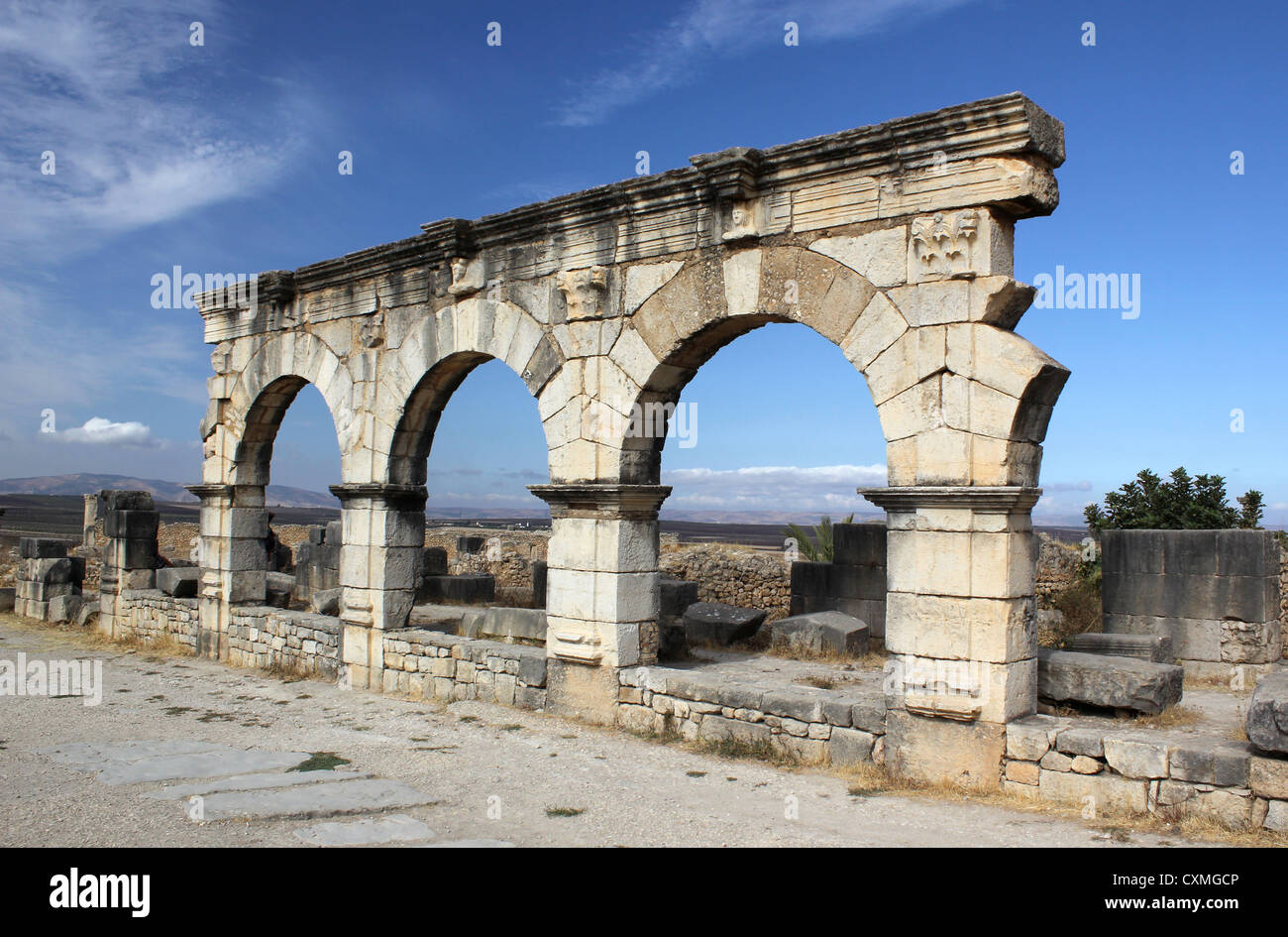 Stone carved arches at Roman Volubilis World Heritage Site against  a blue sky Stock Photo