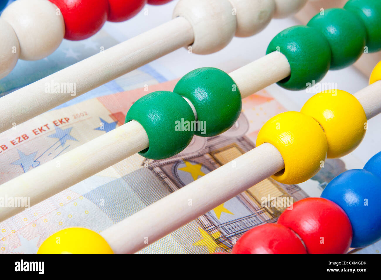 Education concept - Abacus with many colorful beads and banknotes in background Stock Photo