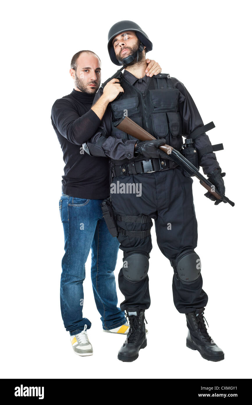 an evil villain threatening a swat officer with a gun Stock Photo