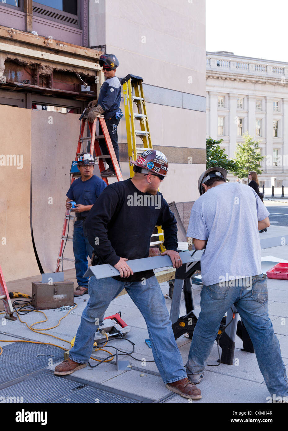 Construction workers repairing exterior of building - Washington, DC USA Stock Photo