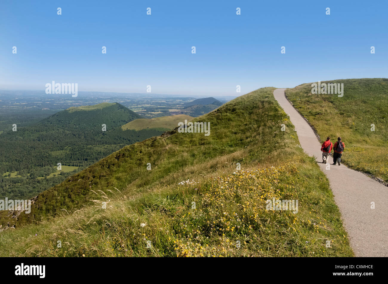Hikers and view from Puy de Dome onto the volcanic landscape of the Chaine des Puys, Massif Central, Auvergne, France, Europe Stock Photo