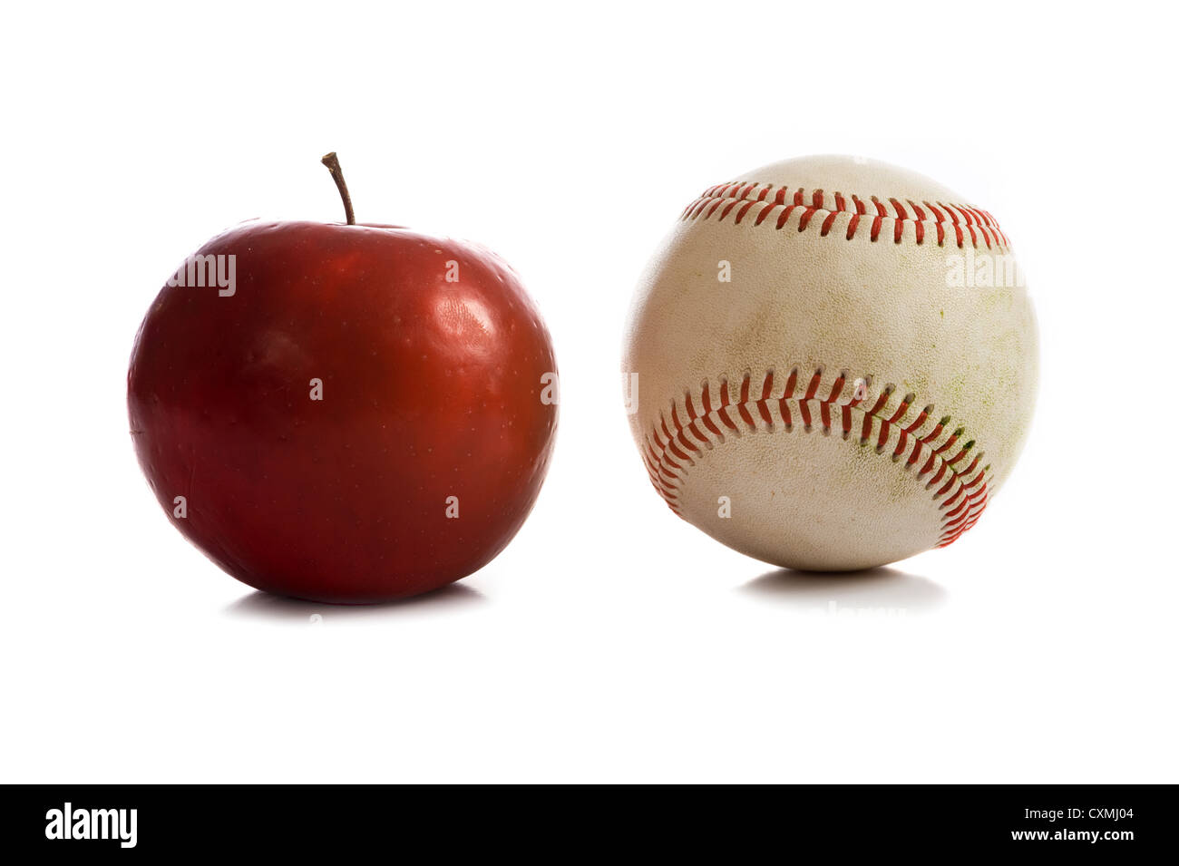 A red Rome apple and a baseball on a white background, symbols of the American summertime, with copy space Stock Photo