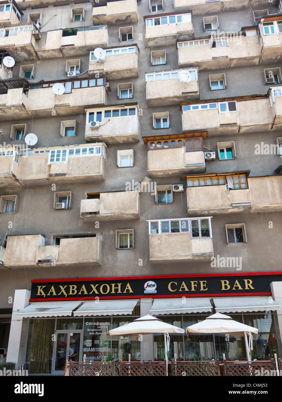 old apartment block with Segafredo cafe, Rudaki Street, Dushanbe, Tajikistan Stock Photo