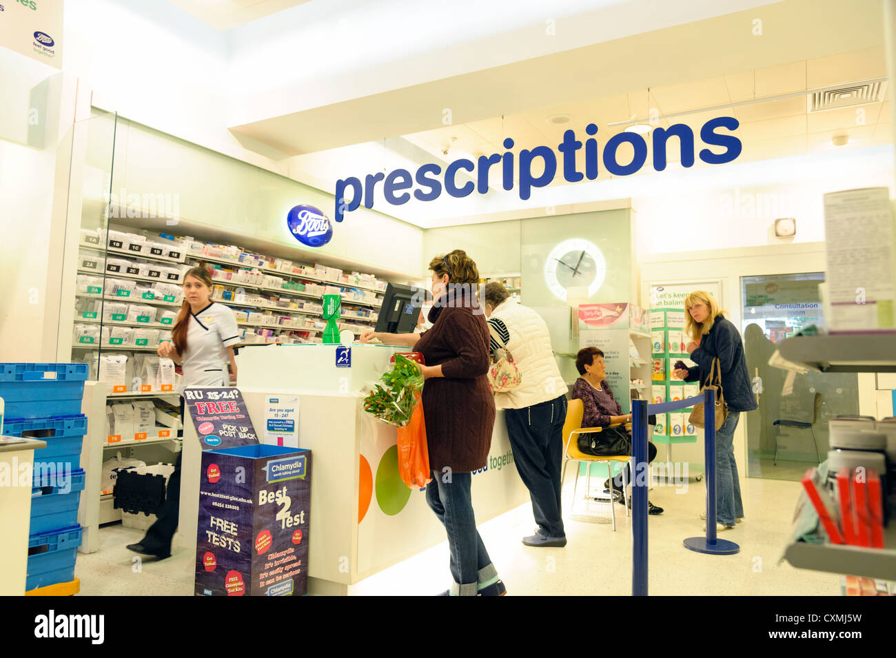 Boots chemist prescription counter inside the store, in Cheltenham, UK. Stock Photo