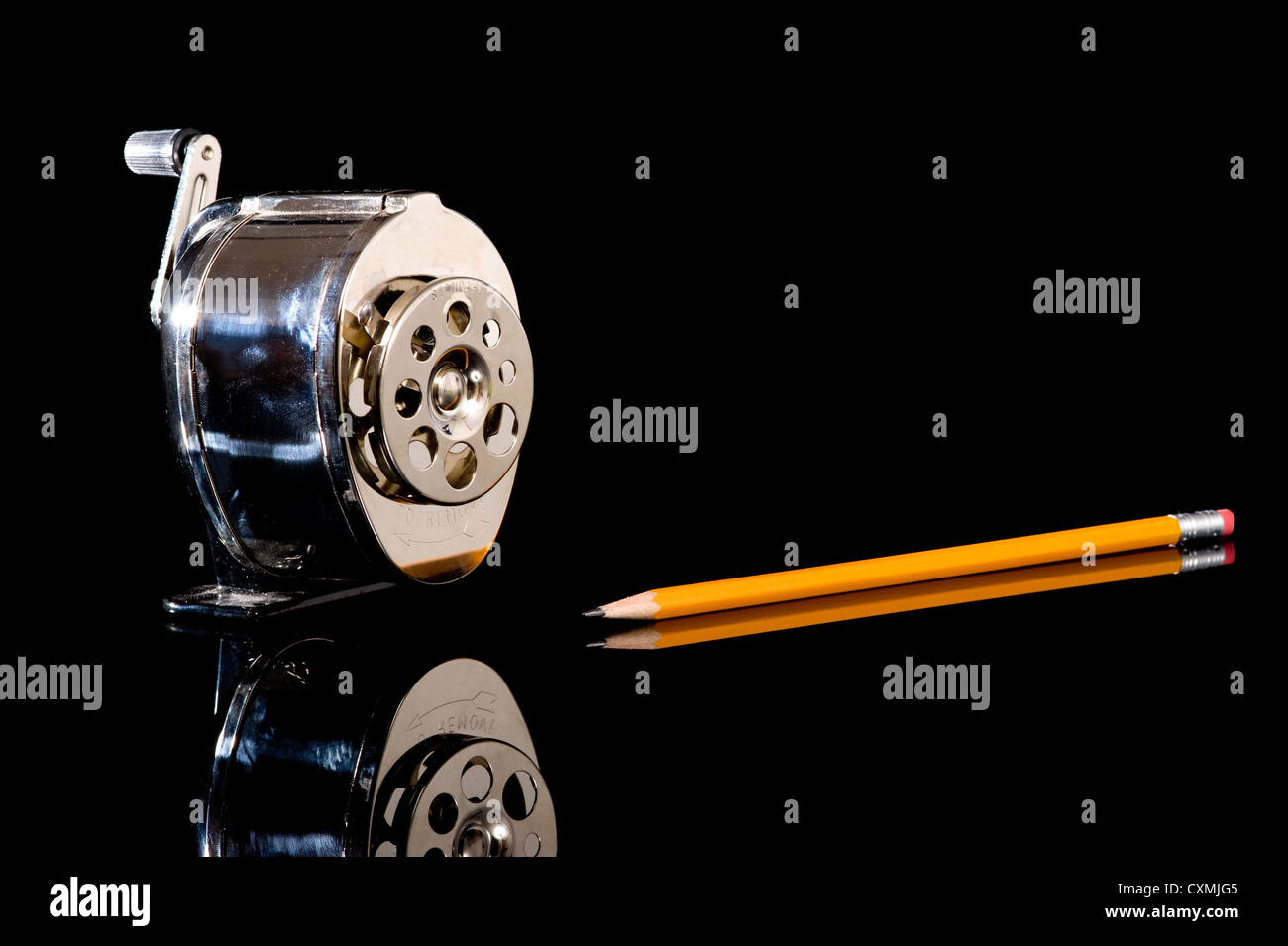 A pencil sharpener and a yellow pencil on a black background with copy space Stock Photo